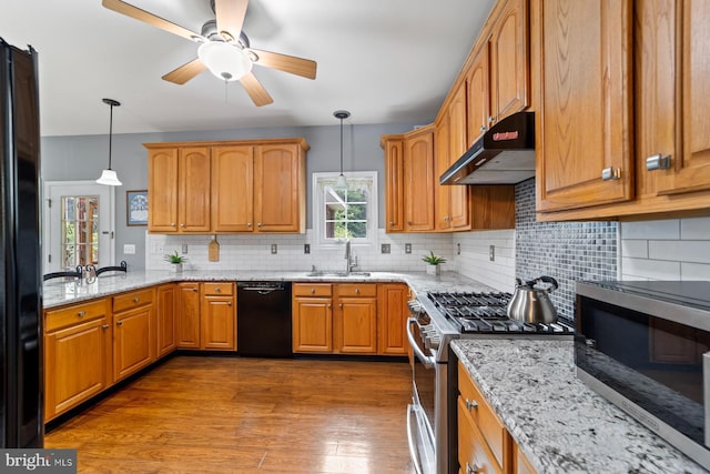 114 Ketterer Ct, Lawrence, NJ 08648 - kitchen with black appliances, under cabinet range hood, ceiling fan, light stone countertops, and decorative backsplash