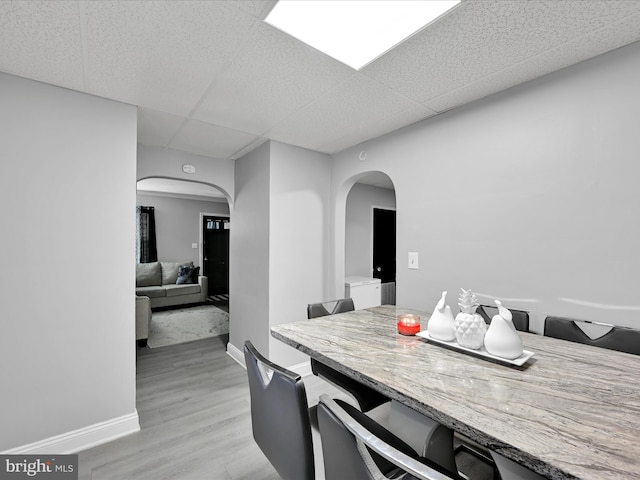 332 W Maple St, York, PA 17401 - dining room with arched walkways, a drop ceiling, and light wood finished floors