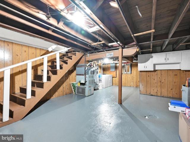 332 W Maple St, York, PA 17401 - unfinished below grade area with heating unit, stairs, wood walls, and washing machine and dryer