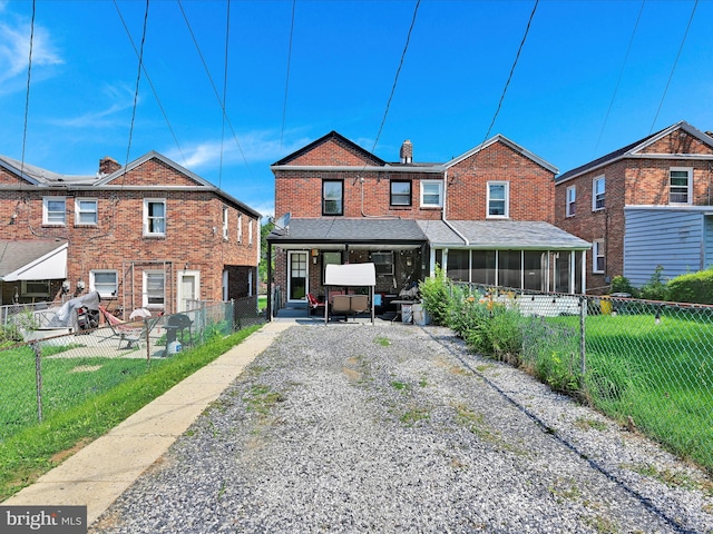 332 W Maple St, York, PA 17401 - back of property featuring a sunroom, driveway, a fenced backyard, and a carport