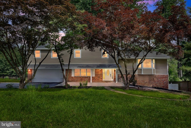 6612 Jacks Ct, Mount Airy, MD 21771 - back of property at dusk featuring brick siding, a garage, and driveway