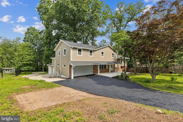 6612 Jacks Ct, Mount Airy, MD 21771 - view of front of property with an attached garage, asphalt driveway, covered porch, and brick siding