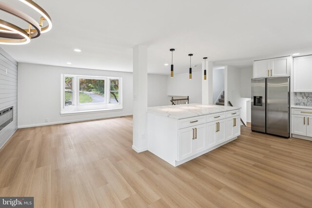 6612 Jacks Ct, Mount Airy, MD 21771 - kitchen featuring stainless steel refrigerator with ice dispenser, light wood-type flooring, light stone counters, white cabinetry, and recessed lighting