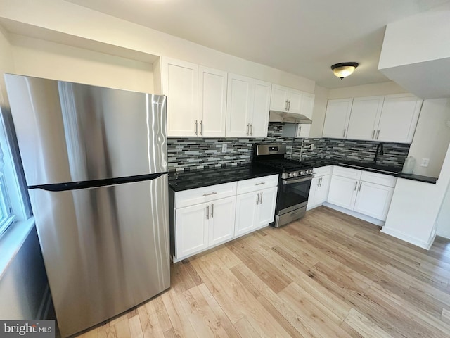 7269 Rutland St, Philadelphia, PA 19149 - kitchen with appliances with stainless steel finishes, under cabinet range hood, dark countertops, and white cabinetry
