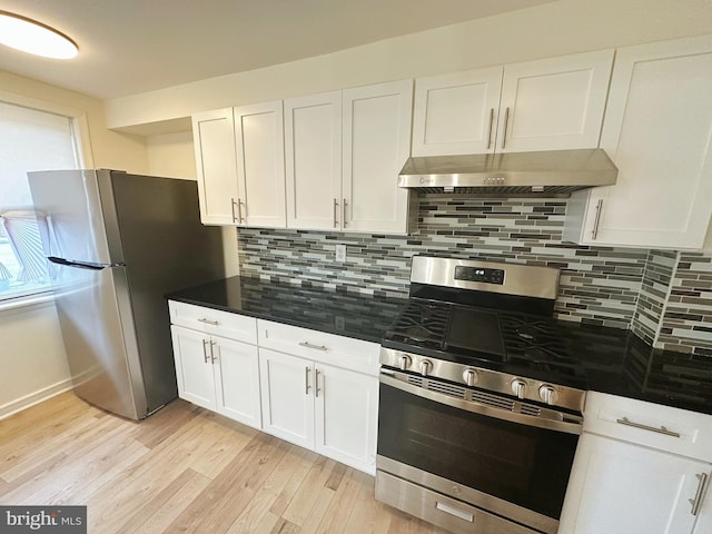 7269 Rutland St, Philadelphia, PA 19149 - kitchen with stainless steel appliances, under cabinet range hood, white cabinetry, light wood-style floors, and tasteful backsplash