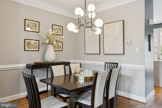 1206 N Pitt St, Alexandria, VA 22314 - dining room featuring a chandelier, wood finished floors, and ornamental molding