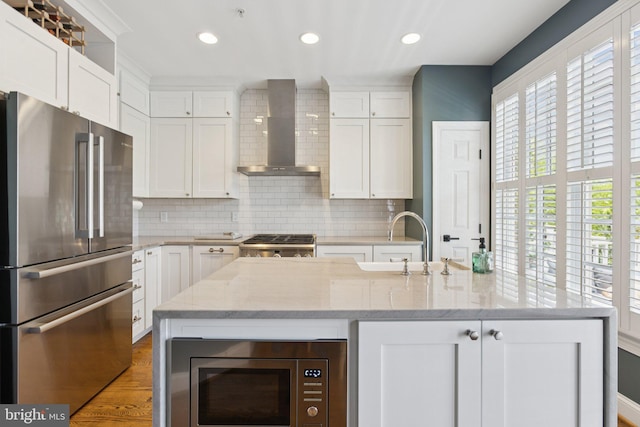 1206 N Pitt St, Alexandria, VA 22314 - kitchen featuring stainless steel appliances, wall chimney range hood, tasteful backsplash, white cabinetry, and recessed lighting