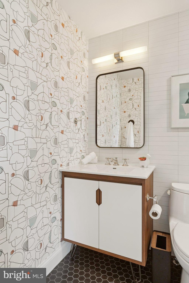 1206 N Pitt St, Alexandria, VA 22314 - bathroom featuring vanity, tile walls, and tile patterned flooring
