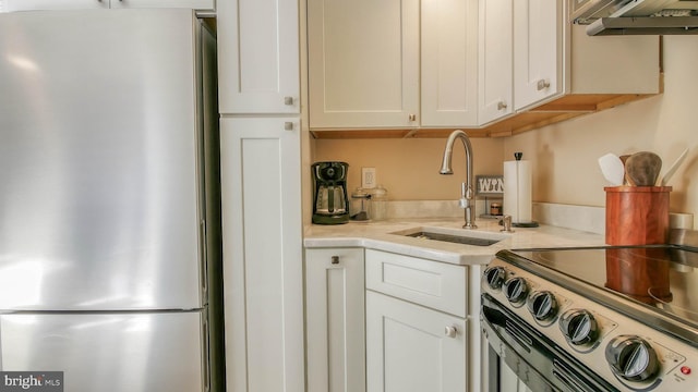 108 Montpelier Ave Unit 214, Atlantic City, NJ 08401 - kitchen featuring freestanding refrigerator, light countertops, extractor fan, and white cabinets