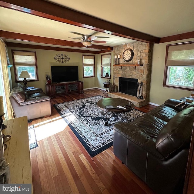 82 Blue Fox Ln, Richboro, PA 18954 - living room with beamed ceiling, wood finished floors, a stone fireplace, and a ceiling fan