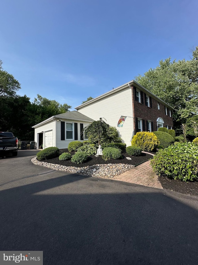 82 Blue Fox Ln, Richboro, PA 18954 - view of side of home featuring a garage and asphalt driveway