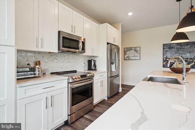 1761 Old Meadow Rd Unit 412, Mclean, VA 22102 - kitchen with appliances with stainless steel finishes, white cabinetry, tasteful backsplash, dark wood-style floors, and recessed lighting