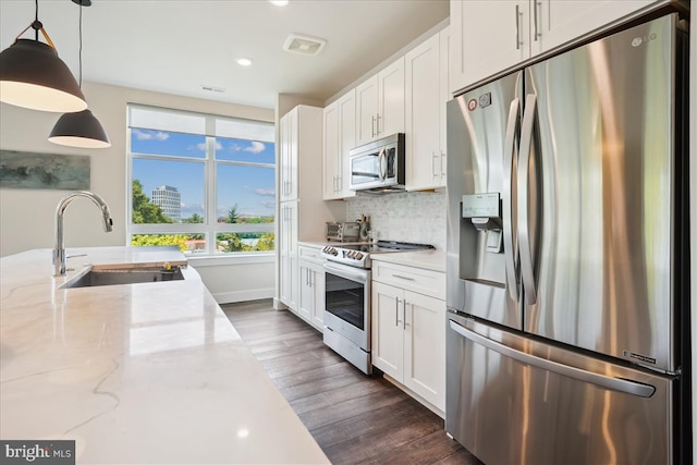 1761 Old Meadow Rd Unit 412, Mclean, VA 22102 - kitchen featuring stainless steel appliances, dark wood-style floors, white cabinetry, backsplash, and decorative light fixtures