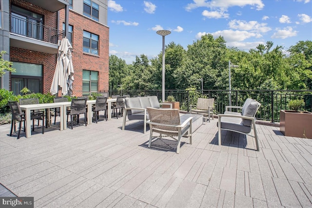 1761 Old Meadow Rd Unit 412, Mclean, VA 22102 - view of patio featuring an outdoor living space, outdoor dining area, and view of wooded area