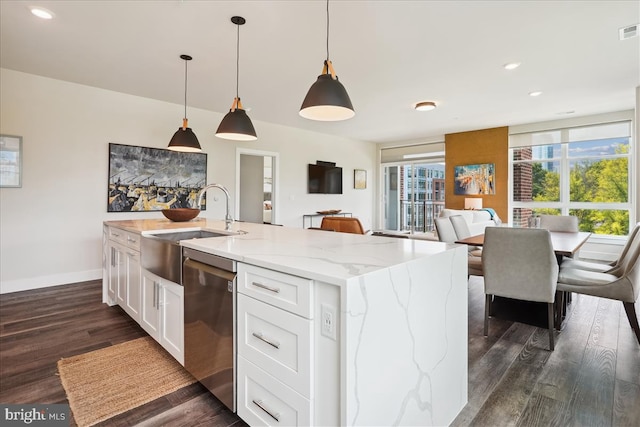 1761 Old Meadow Rd Unit 412, Mclean, VA 22102 - kitchen with stainless steel dishwasher, dark wood finished floors, white cabinets, light stone counters, and a center island with sink