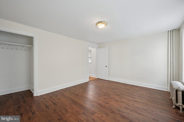 445 Dupont St, Philadelphia, PA 19128 - unfurnished bedroom with radiator, dark wood-style flooring, and a closet