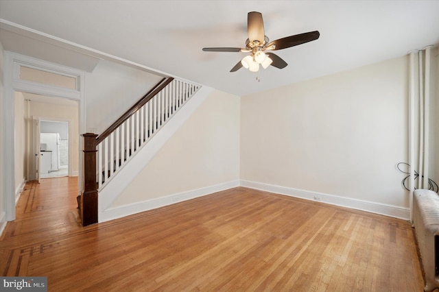 445 Dupont St, Philadelphia, PA 19128 - unfurnished living room featuring a ceiling fan, stairway, light wood finished floors, and radiator