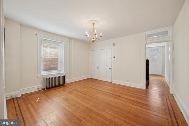 445 Dupont St, Philadelphia, PA 19128 - unfurnished dining area with radiator heating unit, a chandelier, and light wood finished floors