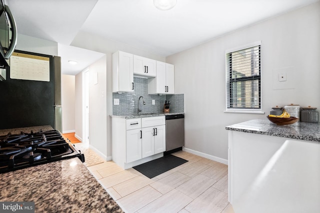 2074 Royal Fern Ct Unit 1C, Reston, VA 20191 - kitchen featuring stainless steel dishwasher, tasteful backsplash, white cabinets, stone countertops, and gas stove
