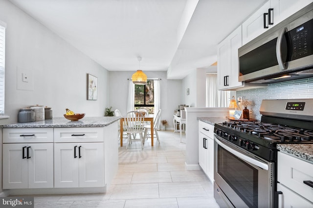 2074 Royal Fern Ct Unit 1C, Reston, VA 20191 - kitchen with appliances with stainless steel finishes, tasteful backsplash, white cabinetry, light stone counters, and light tile patterned floors