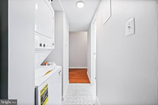 2074 Royal Fern Ct Unit 1C, Reston, VA 20191 - laundry area featuring stacked washer and clothes dryer and light tile patterned flooring