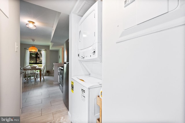 2074 Royal Fern Ct Unit 1C, Reston, VA 20191 - laundry area featuring estacked washer and dryer and light wood-style floors