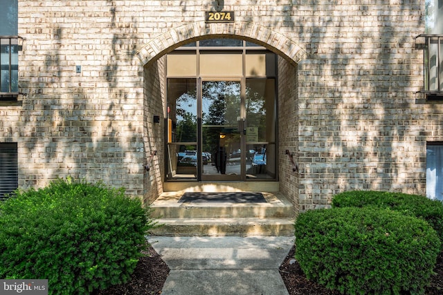2074 Royal Fern Ct Unit 1C, Reston, VA 20191 - view of exterior entry featuring brick siding and french doors