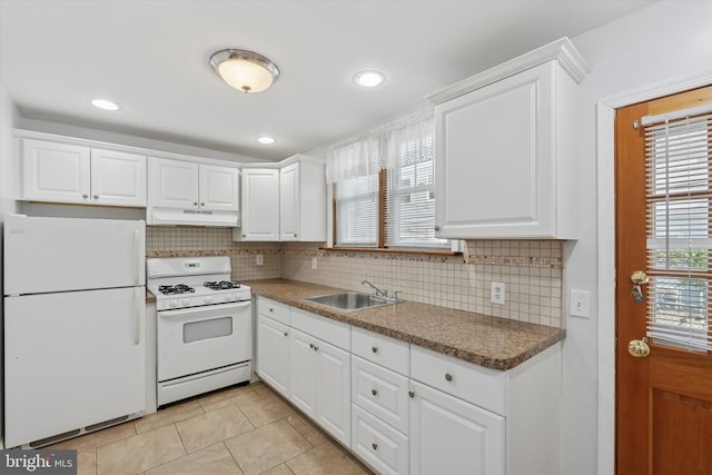 3121 Edgemont St, Philadelphia, PA 19134 - kitchen with white appliances, under cabinet range hood, tasteful backsplash, light tile patterned floors, and recessed lighting