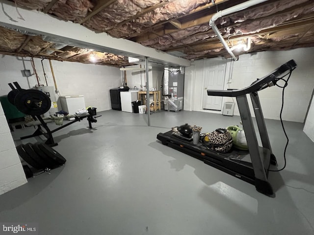 14412 Old Hancock Rd NE, Cumberland, MD 21502 - workout area featuring washing machine and clothes dryer, heating unit, water heater, and concrete block wall