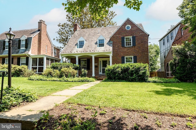 4420 Brandywine St NW, Washington, DC 20016 - cape cod-style house with brick siding, a porch, a front yard, and a chimney