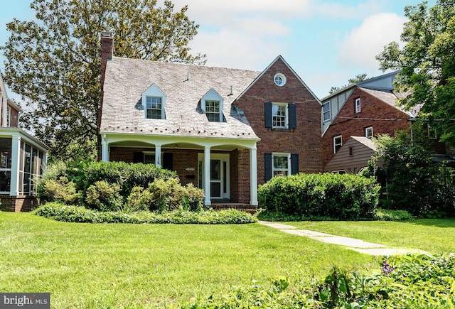 4420 Brandywine St NW, Washington, DC 20016 - view of front of home with a chimney, a high end roof, a front lawn, and brick siding
