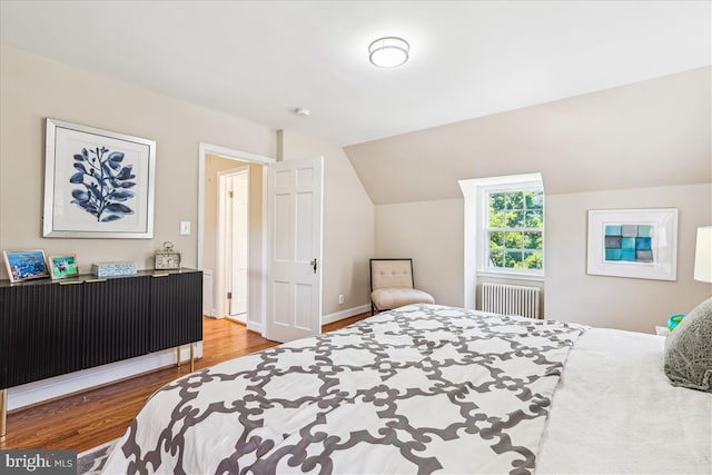 4420 Brandywine St NW, Washington, DC 20016 - bedroom featuring radiator heating unit, wood finished floors, and vaulted ceiling