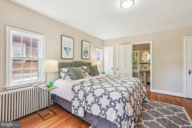 4420 Brandywine St NW, Washington, DC 20016 - bedroom featuring radiator, wood finished floors, and connected bathroom