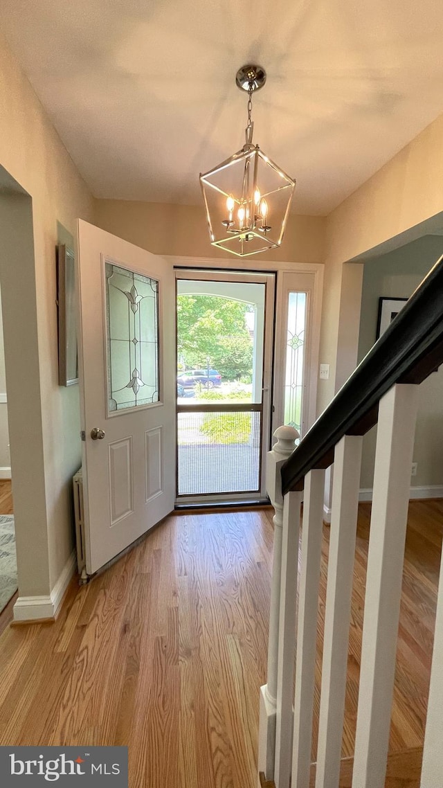 4420 Brandywine St NW, Washington, DC 20016 - entrance foyer with a chandelier, wood finished floors, and radiator heating unit