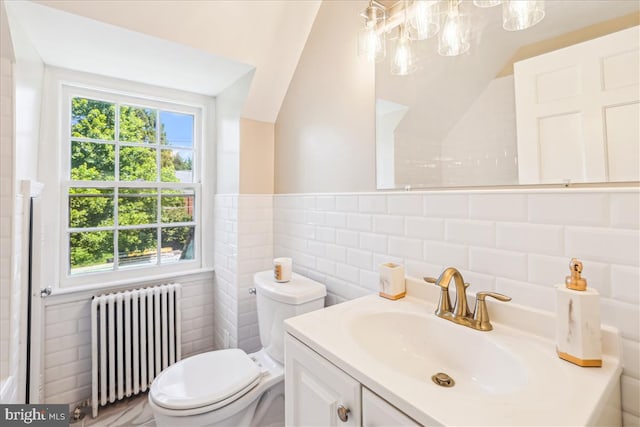 4420 Brandywine St NW, Washington, DC 20016 - bathroom featuring radiator, tile walls, vanity, and healthy amount of natural light