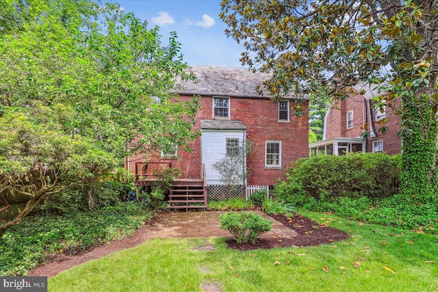 4420 Brandywine St NW, Washington, DC 20016 - back of property featuring brick siding, a wooden deck, and a yard