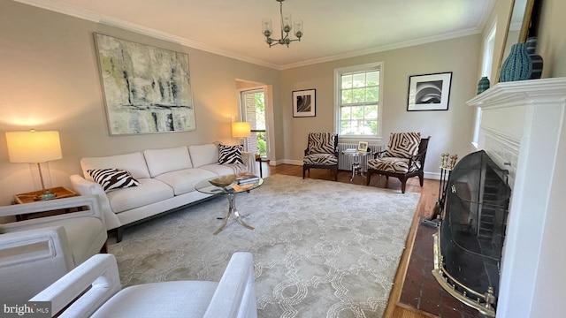 4420 Brandywine St NW, Washington, DC 20016 - living room featuring wood finished floors, ornamental molding, a chandelier, and a fireplace with flush hearth