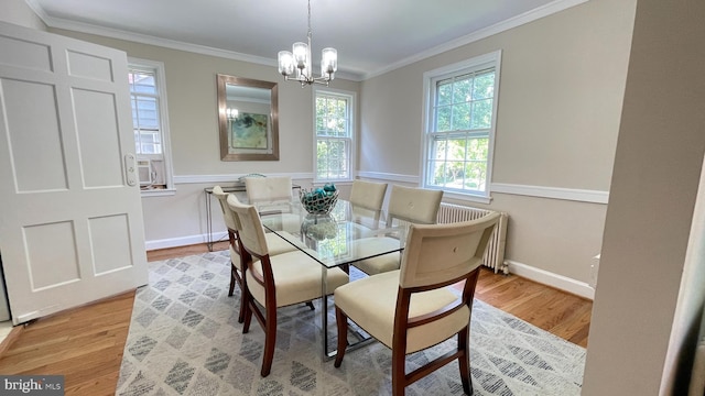 4420 Brandywine St NW, Washington, DC 20016 - dining space featuring radiator, light wood finished floors, crown molding, and a chandelier