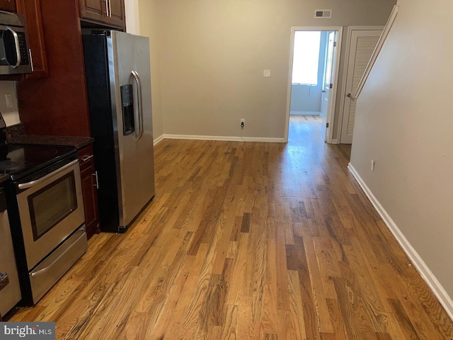 2108 N 17th St, Philadelphia, PA 19121 - kitchen with stainless steel appliances, light wood-style floors, and dark countertops