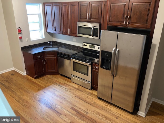 2108 N 17th St, Philadelphia, PA 19121 - kitchen with stainless steel appliances, light wood-style floors, and dark brown cabinetry