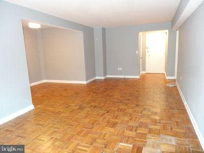3901 Tunlaw Rd NW Unit 202, Washington, DC 20007 - spare room with baseboards