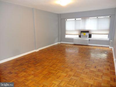 3901 Tunlaw Rd NW Unit 202, Washington, DC 20007 - unfurnished room featuring radiator heating unit and healthy amount of natural light