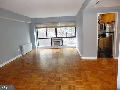 3901 Tunlaw Rd NW Unit 202, Washington, DC 20007 - spare room with radiator and baseboards
