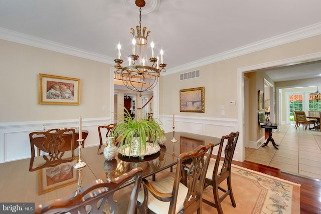 650 S Warren Ave, Malvern, PA 19355 - dining room with a chandelier, crown molding, wood finished floors, and a wainscoted wall