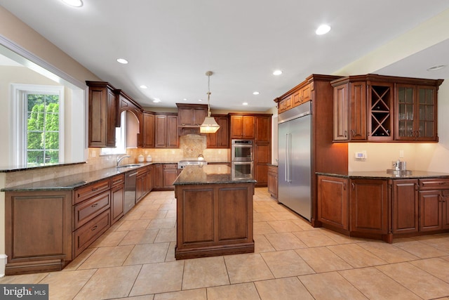 650 S Warren Ave, Malvern, PA 19355 - kitchen with appliances with stainless steel finishes, tasteful backsplash, dark stone countertops, a center island, and recessed lighting