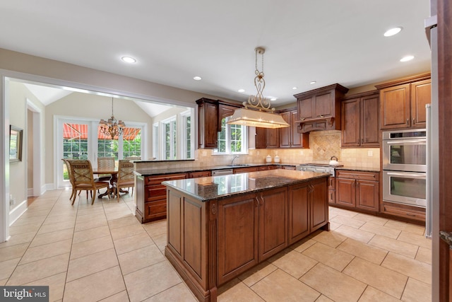 650 S Warren Ave, Malvern, PA 19355 - kitchen featuring a chandelier, stainless steel appliances, backsplash, light tile patterned floors, and custom exhaust hood