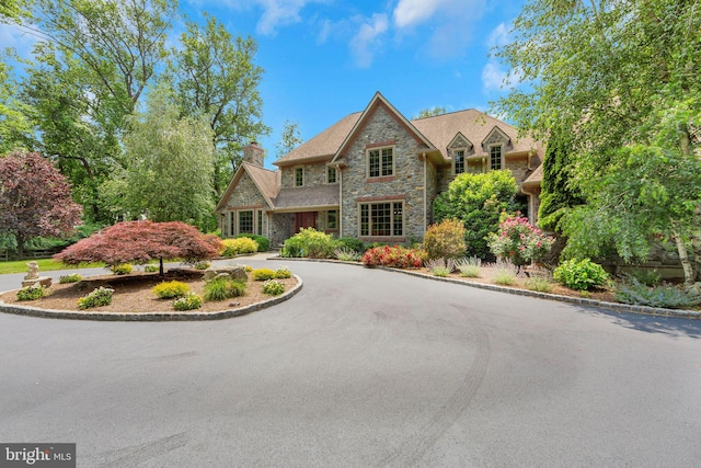 650 S Warren Ave, Malvern, PA 19355 - view of front of home with stone siding and a chimney