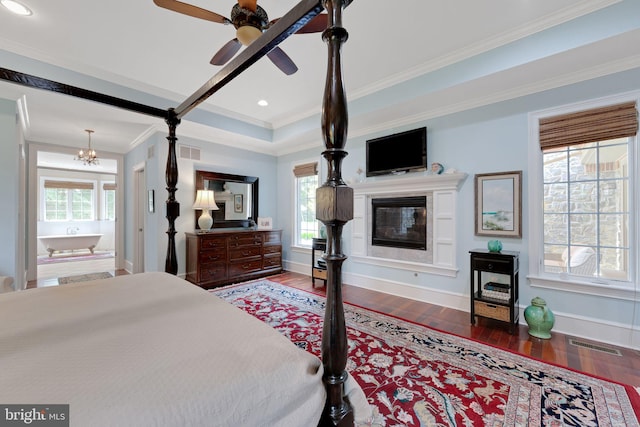 650 S Warren Ave, Malvern, PA 19355 - bedroom featuring wood finished floors, a glass covered fireplace, crown molding, ensuite bathroom, and recessed lighting