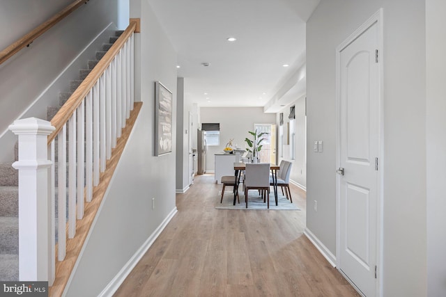 19 N Smallwood St, Baltimore, MD 21223 - hallway with light wood-style floors, stairway, and recessed lighting