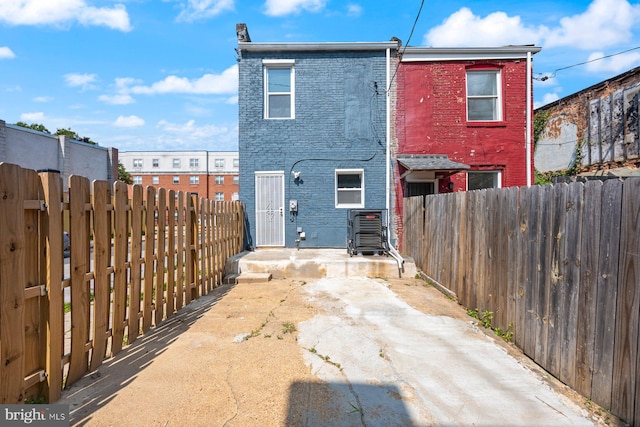 19 N Smallwood St, Baltimore, MD 21223 - rear view of property with brick siding and a fenced backyard